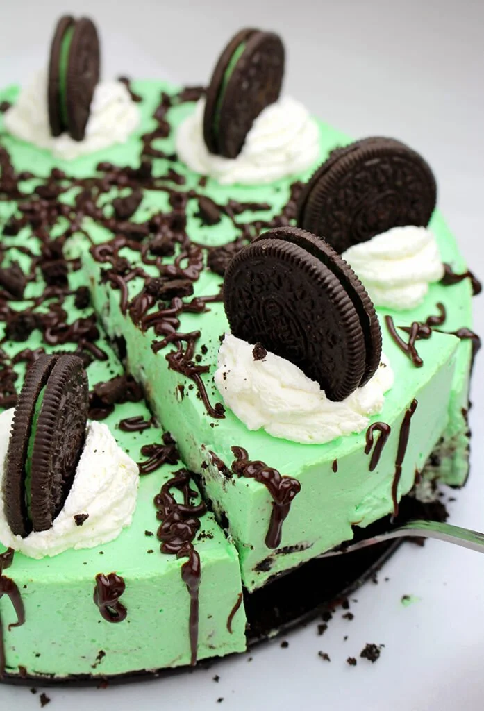 No-bake Oreo mint cheesecake topped with crushed Oreo cookies and mint garnish