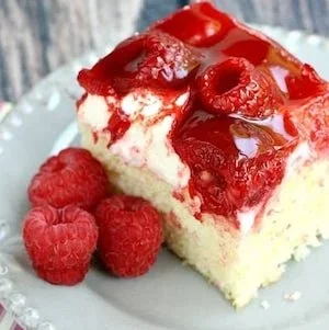 Delicious strawberries and cream cake topped with fresh strawberries and whipped cream.