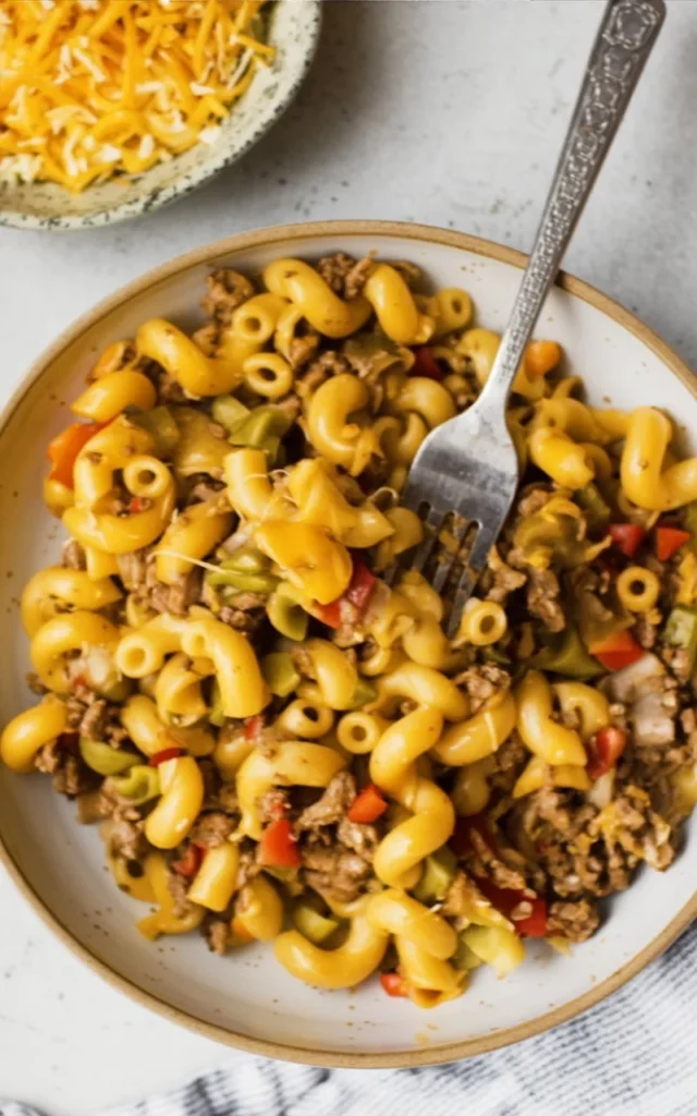 Dish of Taco Macaroni with cheese, beef, and taco seasoning served in a bowl