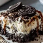 Easy Oreo Dump Cake topped with whipped cream and crushed Oreos
