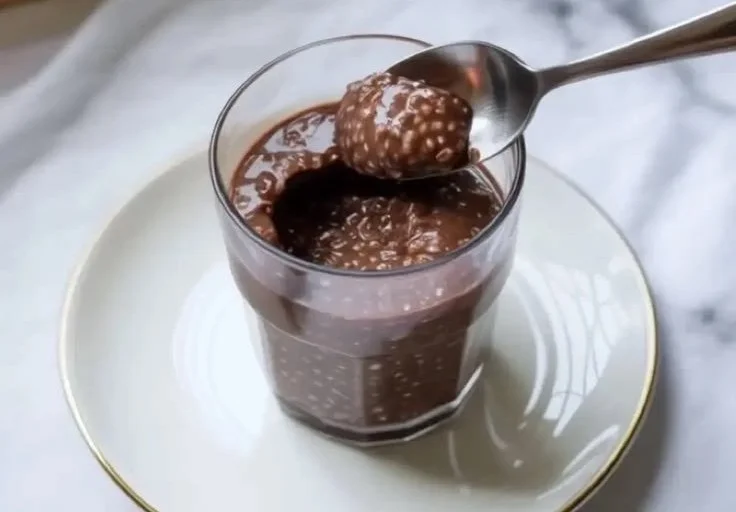 Bowl of healthy chocolate chia pudding topped with berries and nuts