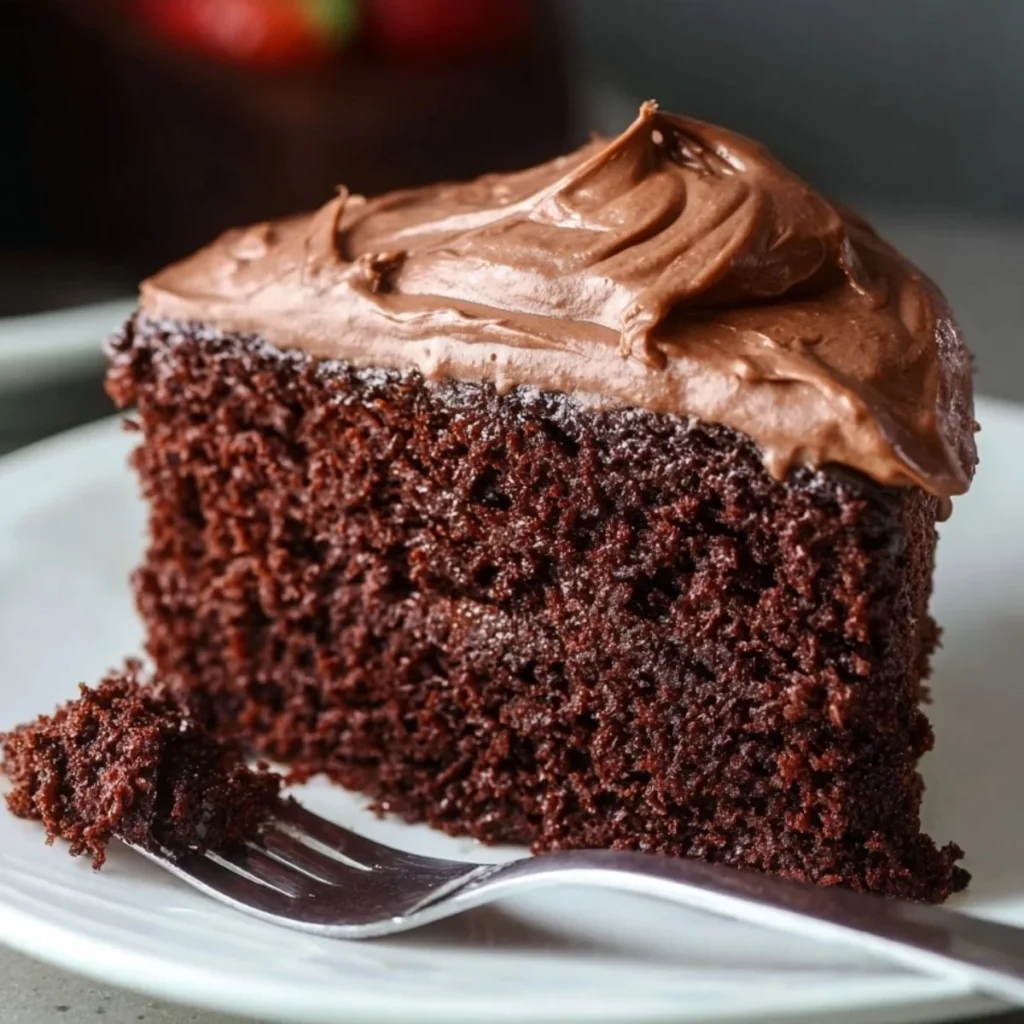 Moist chocolate mayonnaise cake topped with chocolate frosting and sprinkles