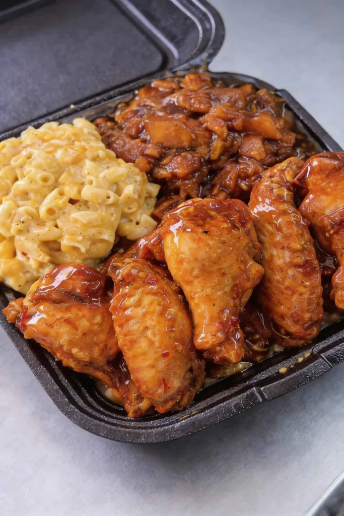 Delicious soul food platter with fried chicken, collard greens, and cornbread