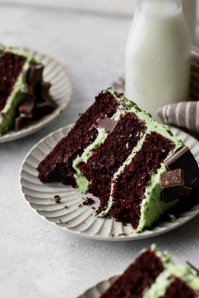Slice of Andes chocolate mint cake topped with green mint frosting