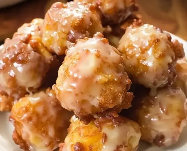 Plate of delicious homemade Apple Fritter Bites with cinnamon glaze.