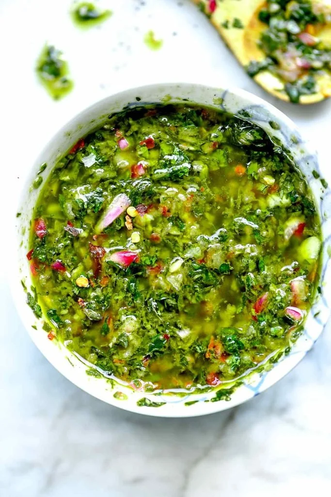 Delicious homemade chimichurri sauce drizzled over grilled steak.