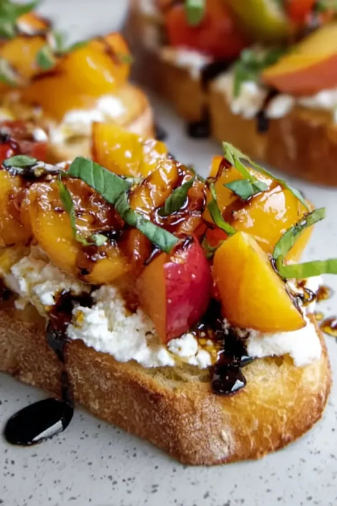 Delicious peach bruschetta topped with whipped ricotta on toasted bread