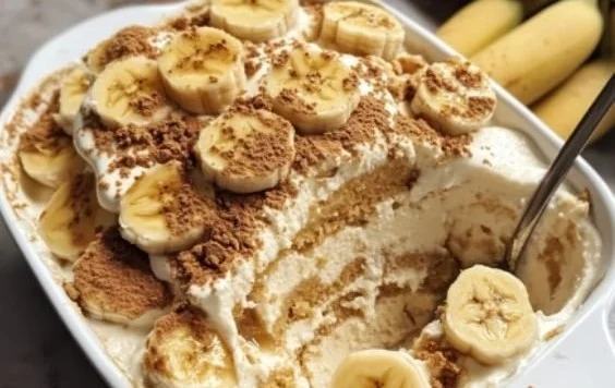 Delicious Biscoff Banana Pudding dessert in a glass with layers of banana and Biscoff cookies