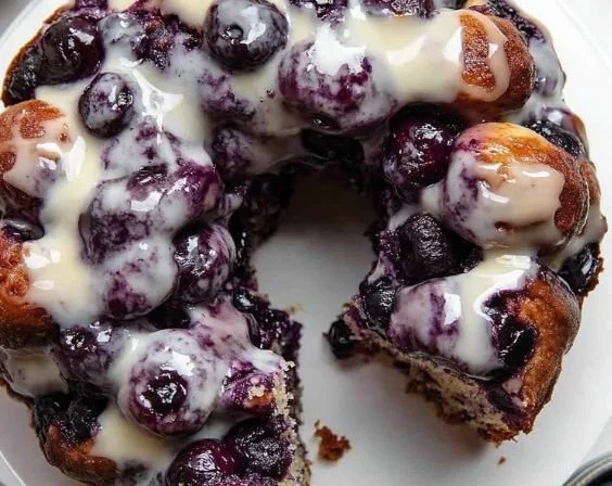 Delicious blueberry monkey bread served on a plate with fresh blueberries