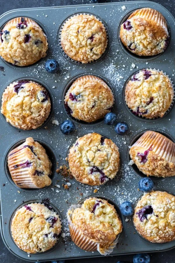Freshly baked blueberry muffins on a cooling rack