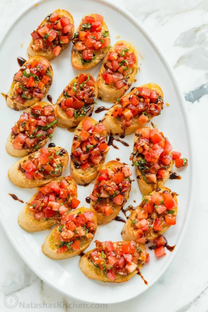 Delicious classic bruschetta topped with fresh tomatoes and basil on toasted bread