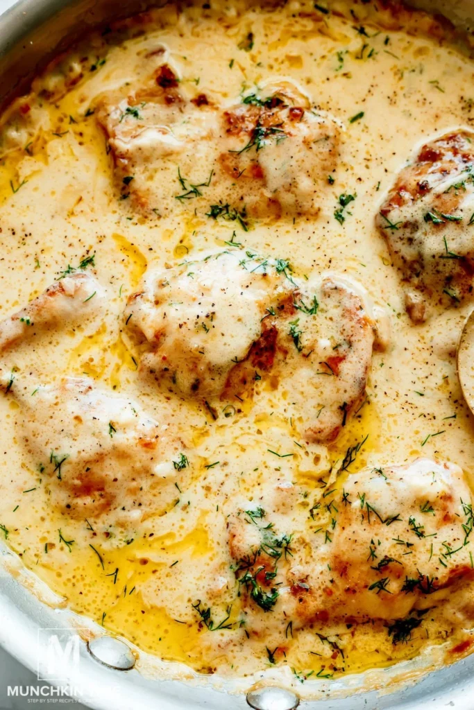 Delicious creamy oven baked chicken thighs served on a plate