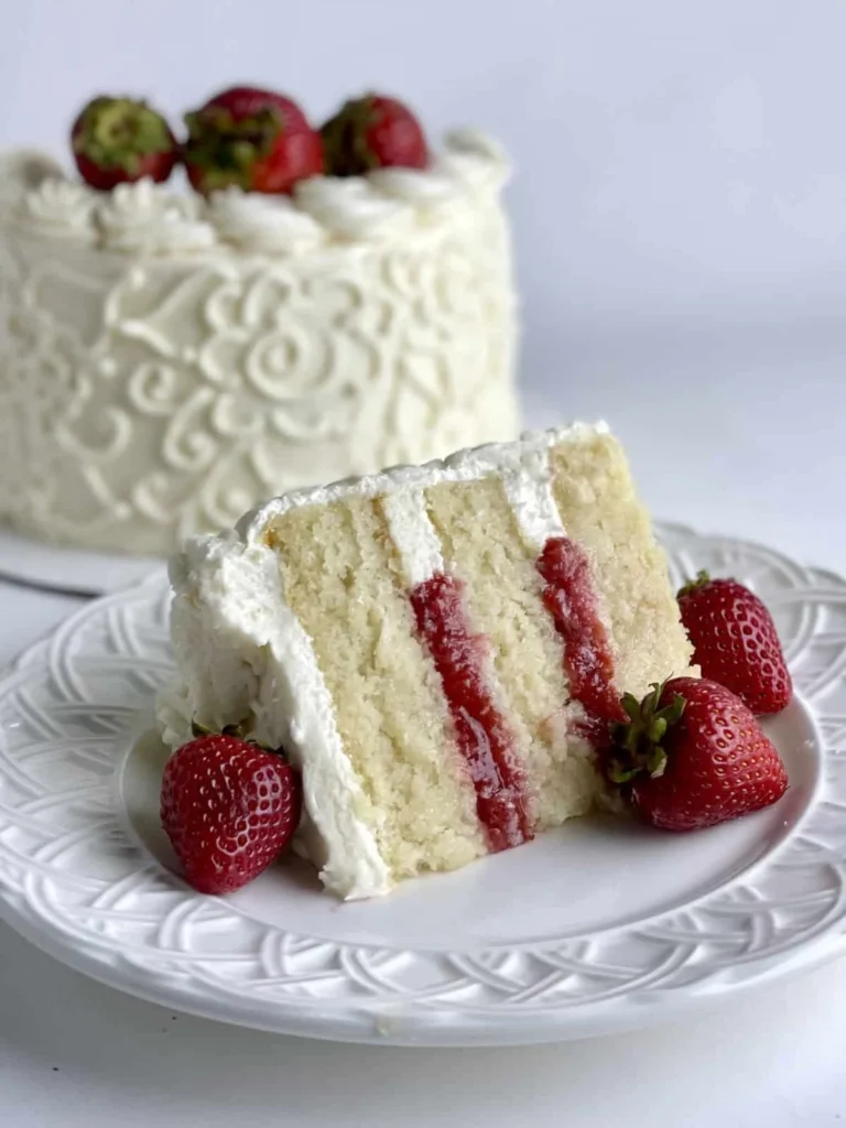 Fluffy vanilla cake with strawberry filling ready to serve