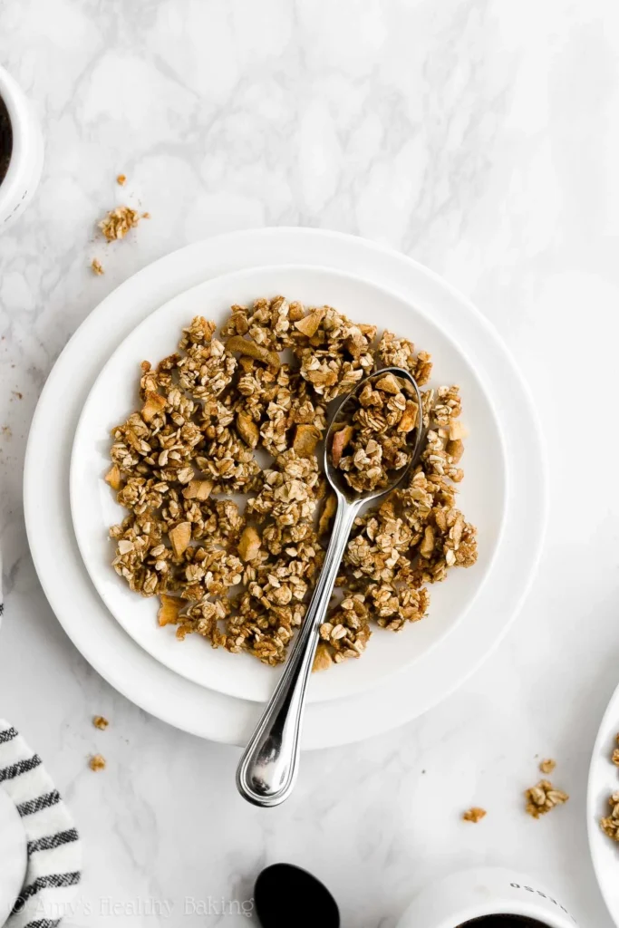 Bowl of healthy apple cinnamon granola topped with fruits