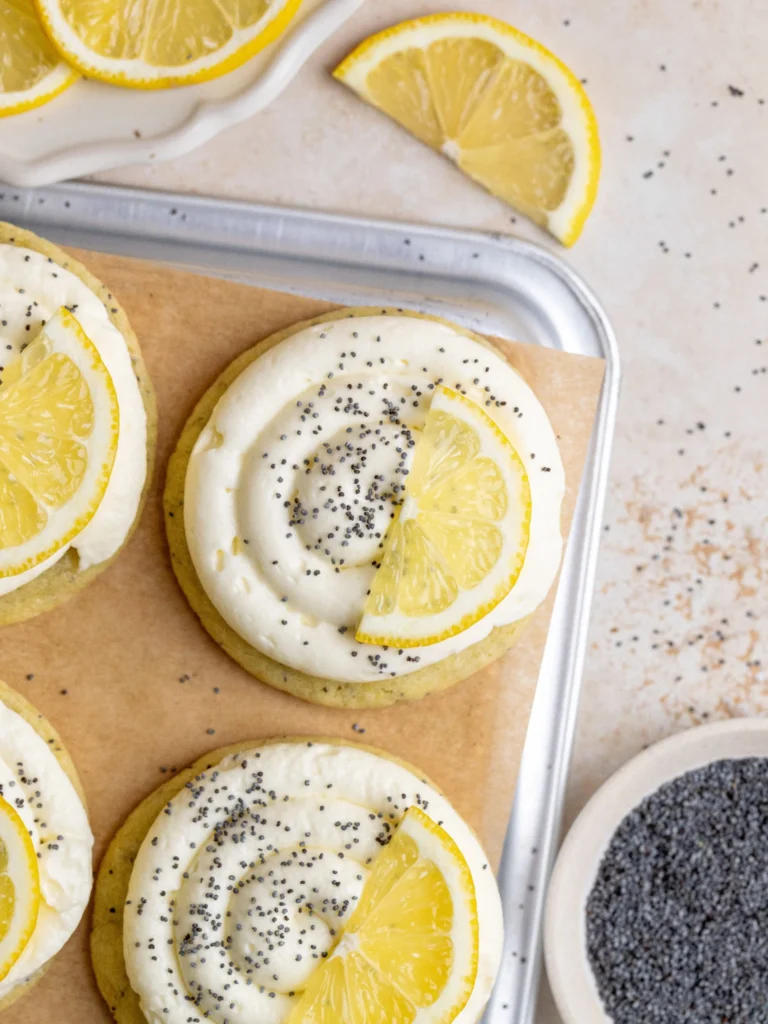Lemon poppy seed cheesecake cookie on a plate with a slice missing