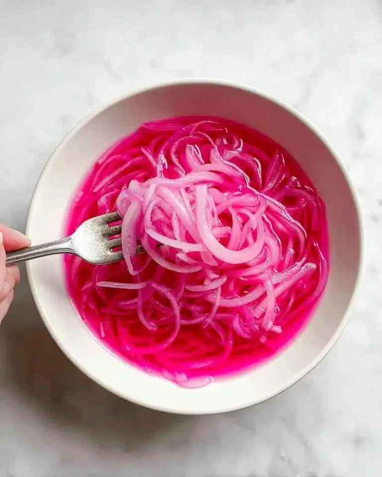 Quick pickled red onions in a jar, ideal for garnishing meals