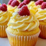 Delicious raspberry lemon cupcakes topped with vibrant frosting and fresh raspberries