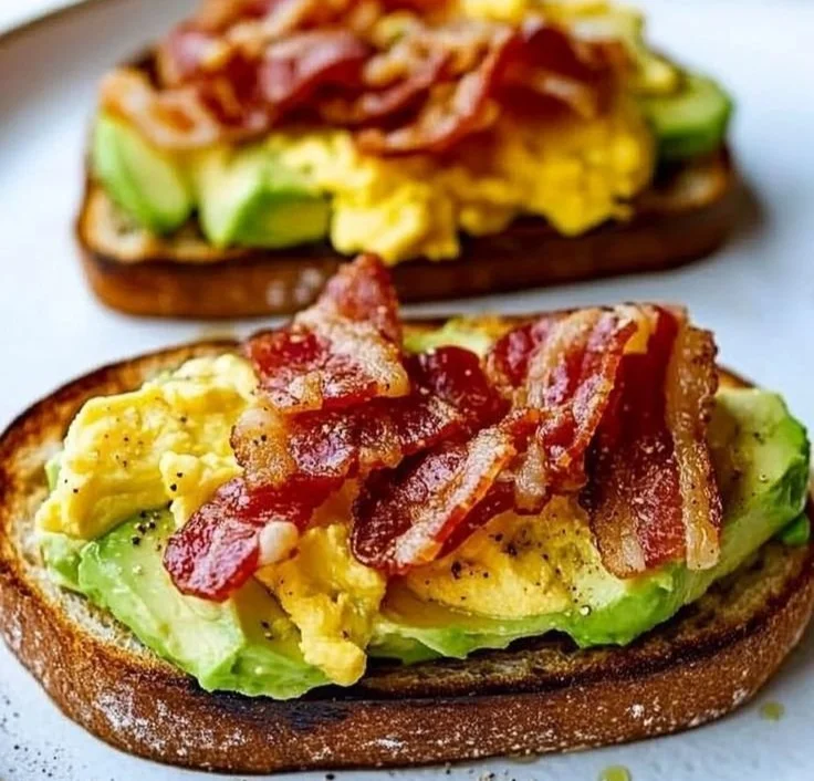 Delicious bacon and egg avocado toast served on a rustic plate