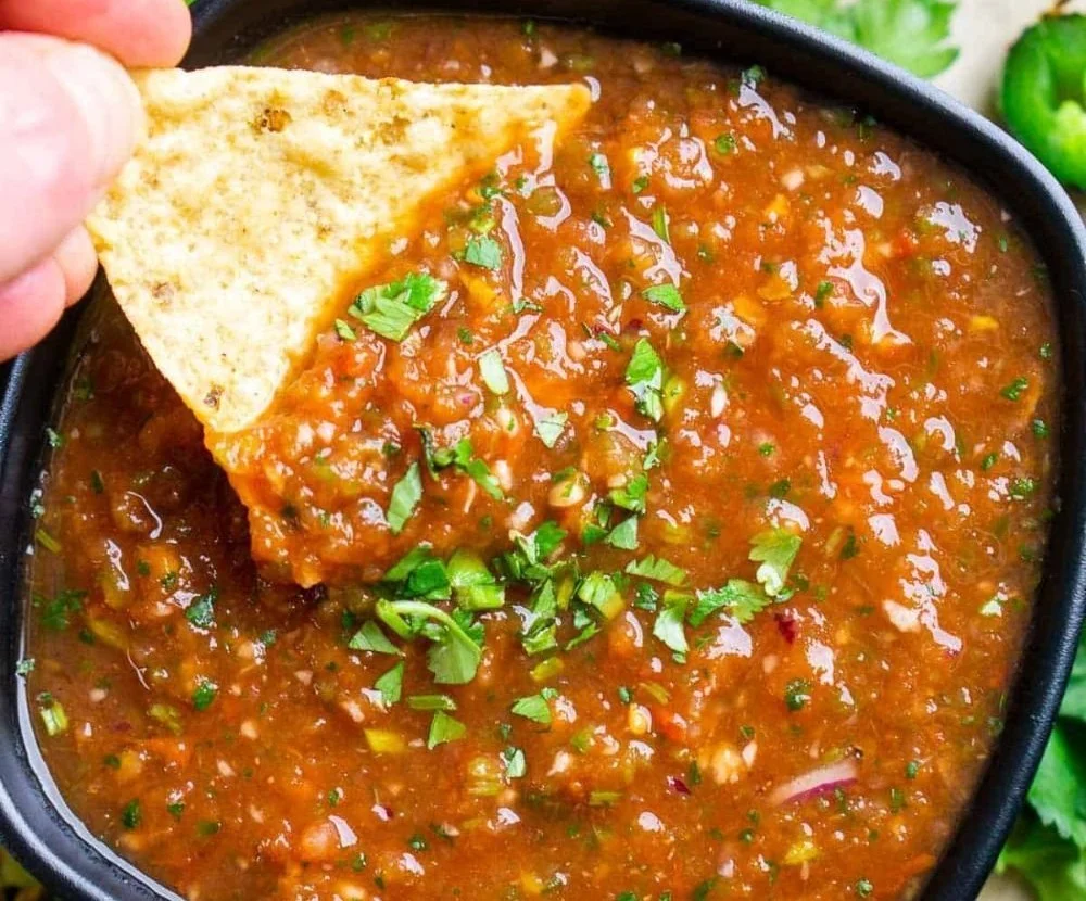 Delicious homemade blender salsa in a bowl with fresh ingredients