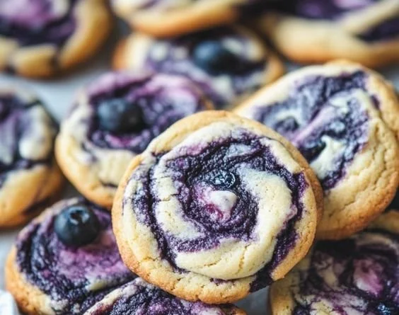 Freshly baked blueberry cheesecake cookies on a cooling rack