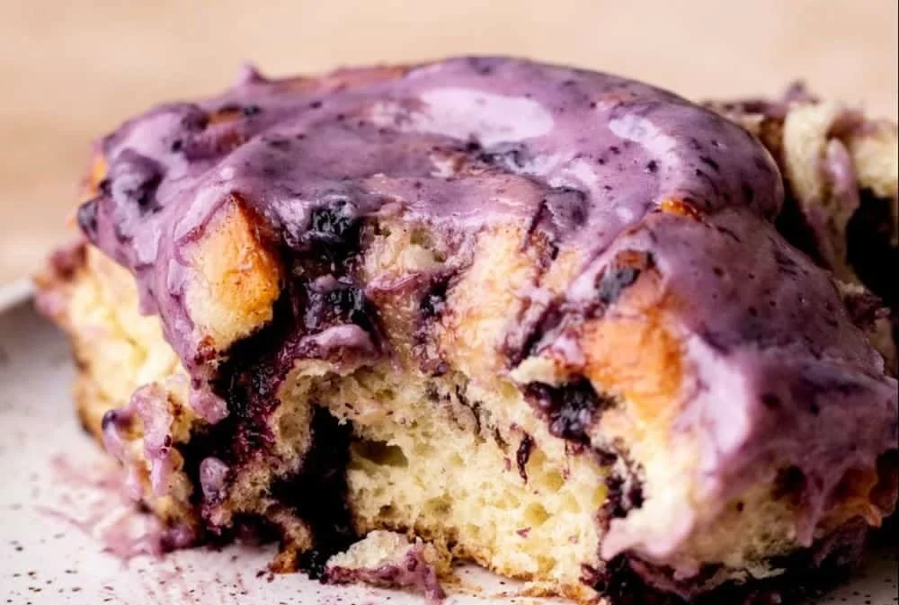 Freshly baked blueberry cinnamon rolls with icing topping