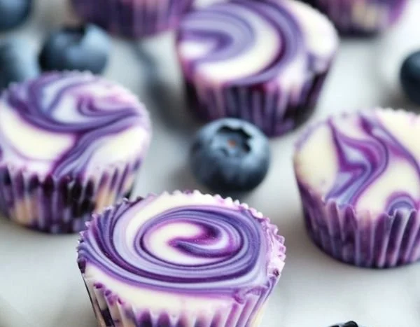 Blueberry swirl yogurt bites in a bowl, showcasing their vibrant color and texture.