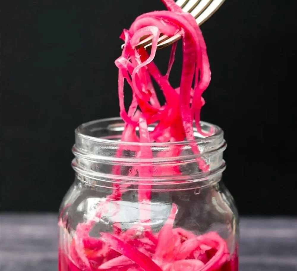 Bobby Flay’s pickled onion recipe with vibrant colors and fresh ingredients.