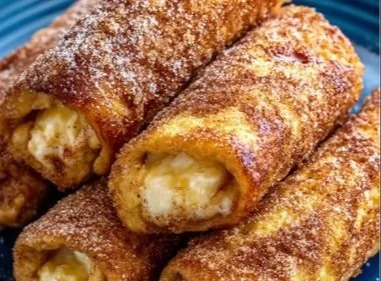 Cinnamon Sugar French Toast Roll-Ups served on a plate with syrup
