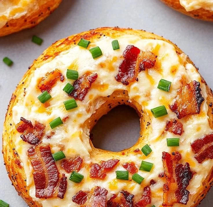 Homemade creamy bacon and cheddar bagels on a wooden table