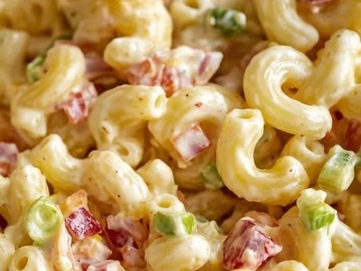 Creamy macaroni salad with bacon and colorful vegetables in a bowl
