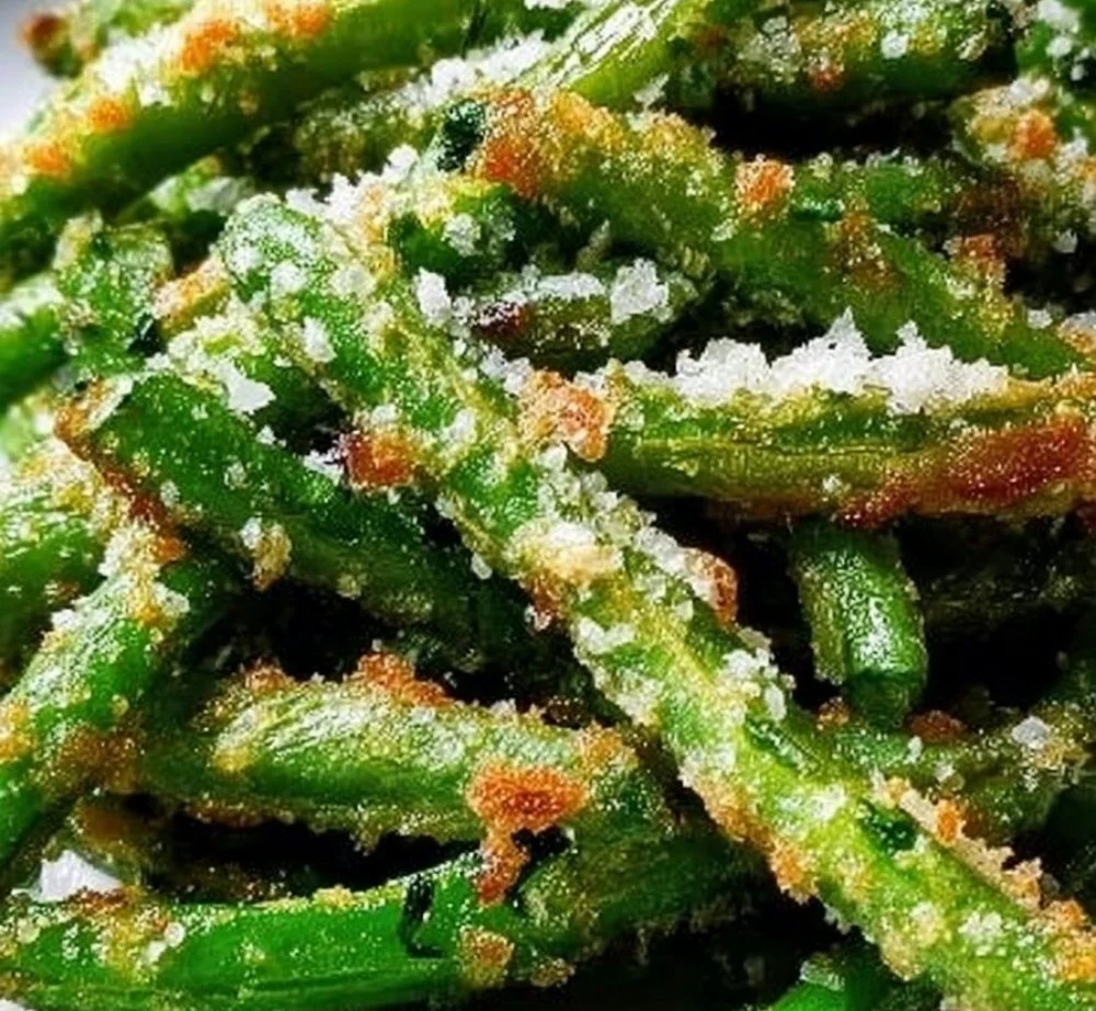 A plate of crispy garlic parmesan green beans, garnished and ready to serve.