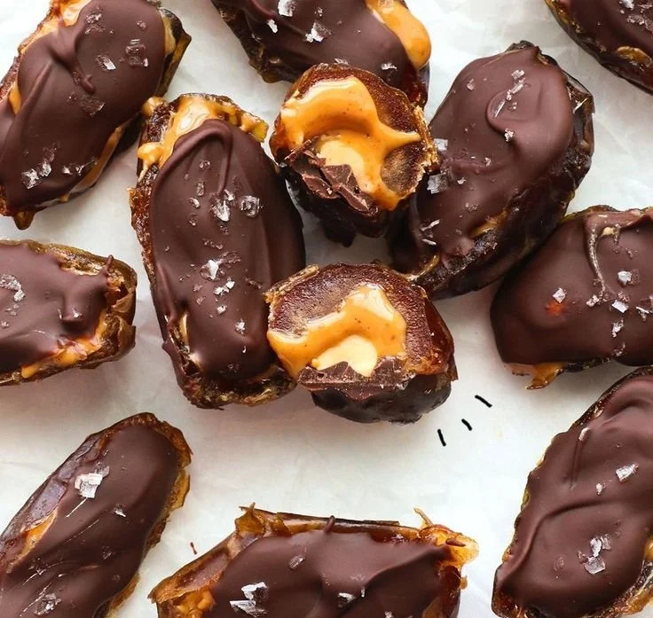 Homemade Date Snickers bars on a wooden table