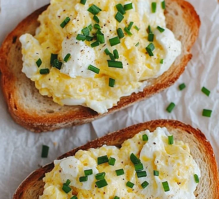 Easy Egg and Ricotta Toast topped with fresh herbs and a sprinkle of pepper