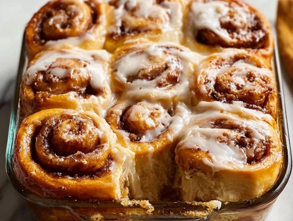 Fluffy banana bread cinnamon rolls with cream cheese frosting on a plate