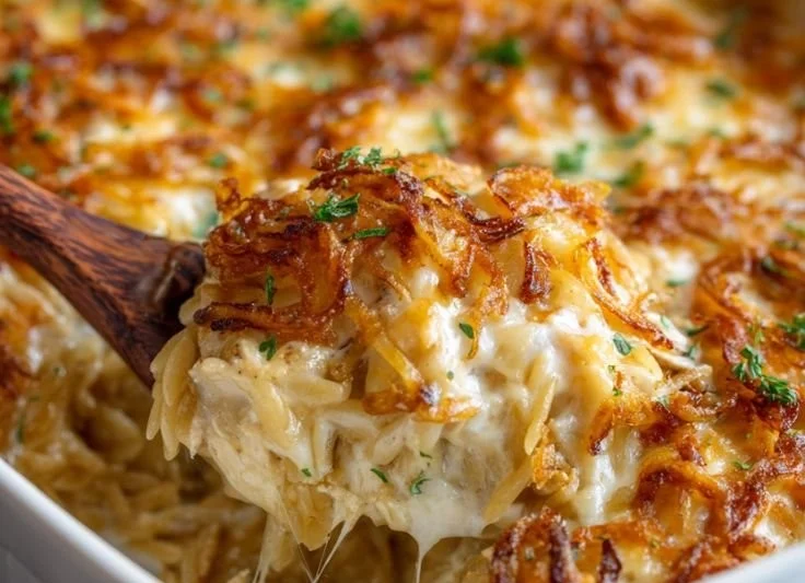 French Onion Chicken Orzo Casserole topped with cheese and herbs