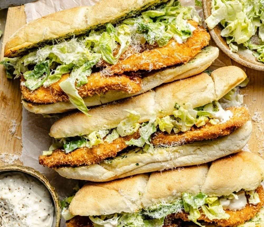Plate of Garlic Butter Chicken Caesar salad featuring juicy chicken and fresh romaine.