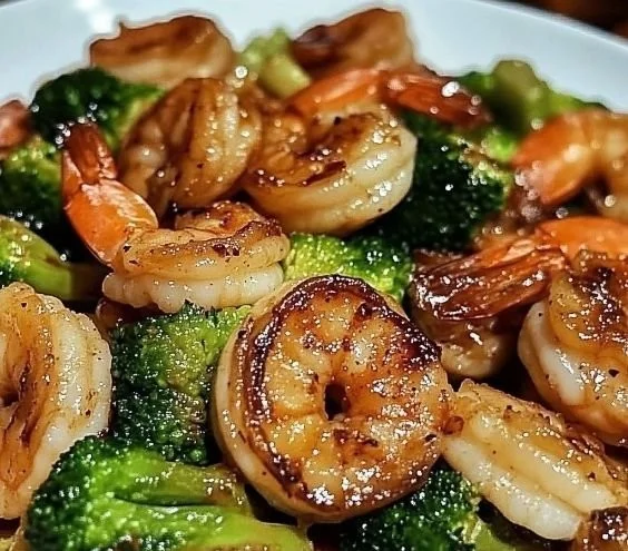 High-protein honey garlic shrimp dish garnished with green onions.