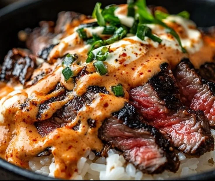 Korean BBQ Steak Rice Bowls with spicy cream sauce garnished with vegetables