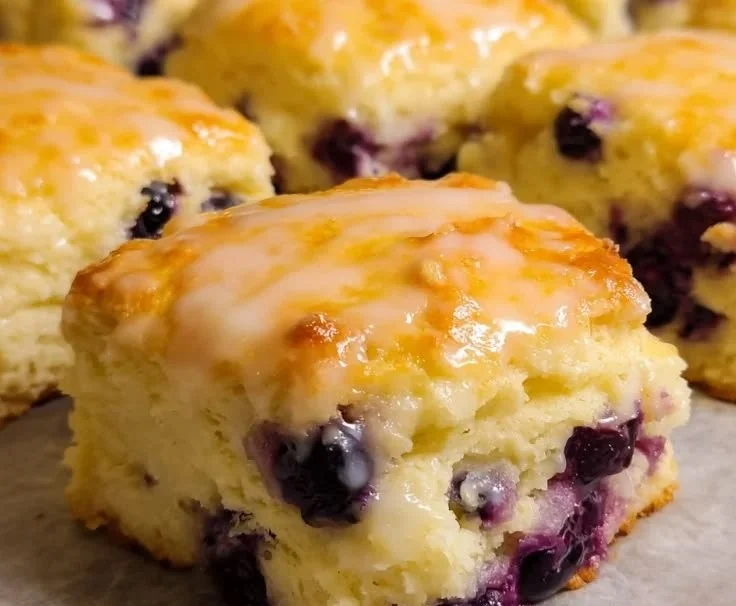 Freshly baked lemon blueberry butter swim biscuits on a cooling rack.