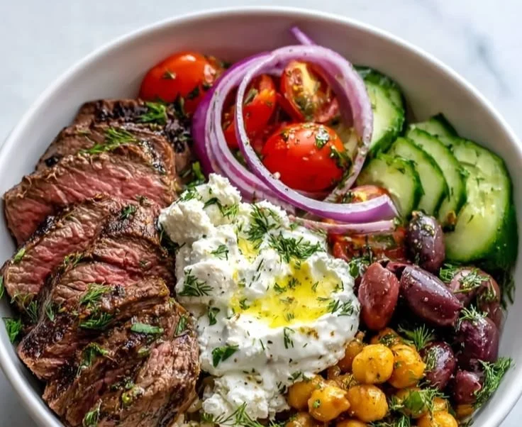 Mediterranean steak bowl with fresh vegetables and grilled steak