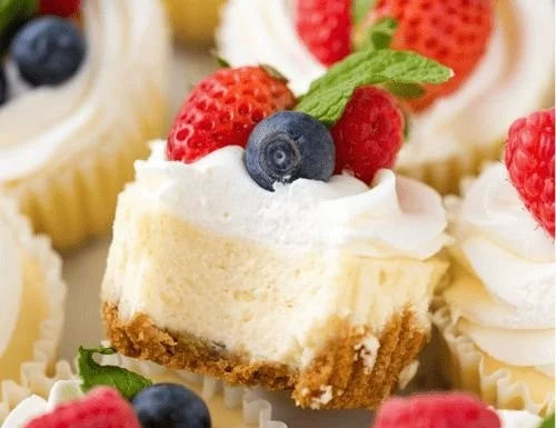 Delicious assortment of Mini Cheesecakes topped with fruit and chocolate.