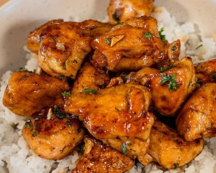 Healthy honey garlic chicken bites served with rice on a plate