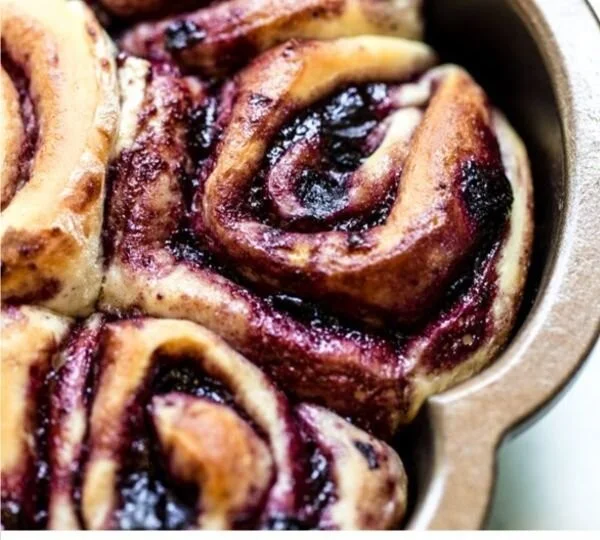 Soft cinnamon rolls from scratch with blueberries on a plate