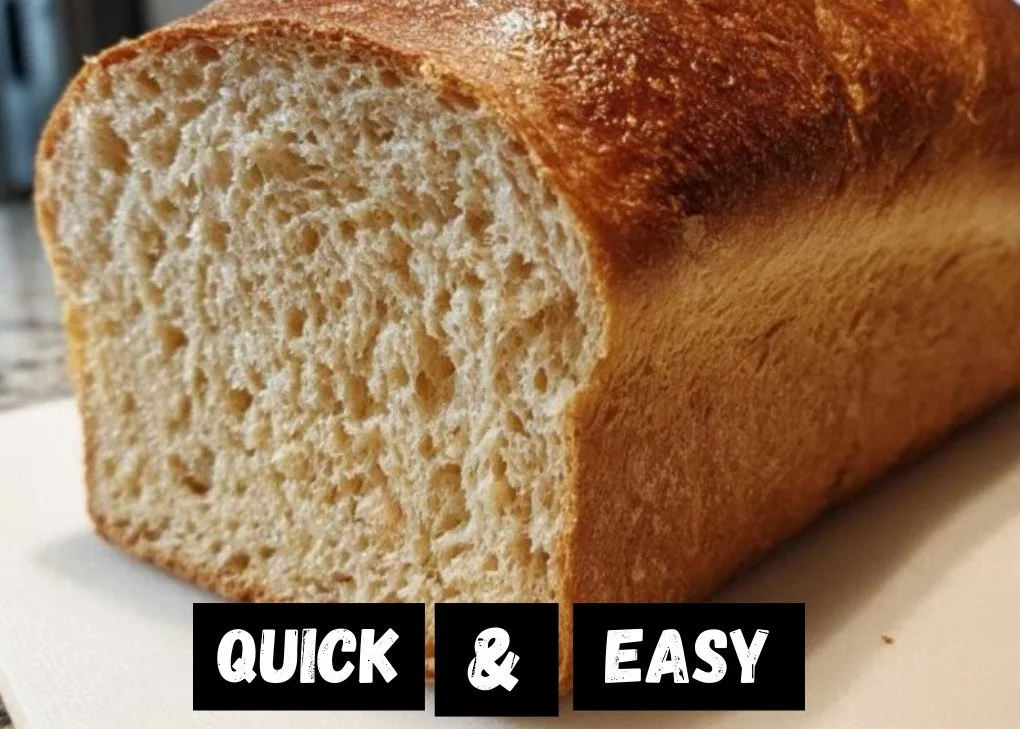 Freshly baked soft whole wheat bread loaf on a wooden cutting board.