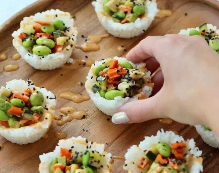 A plate of colorful sushi cups filled with fresh ingredients.