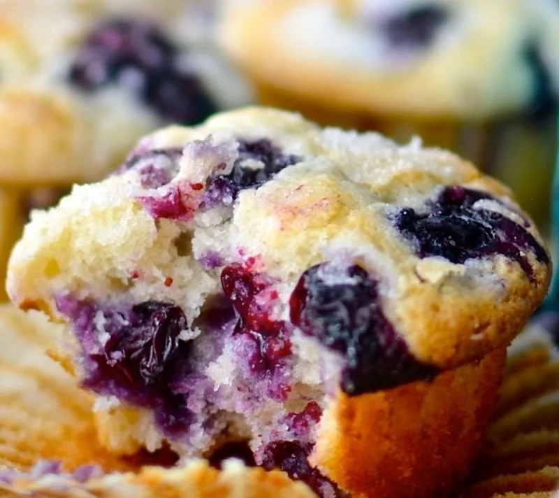 Freshly baked blueberry muffins on a cooling rack