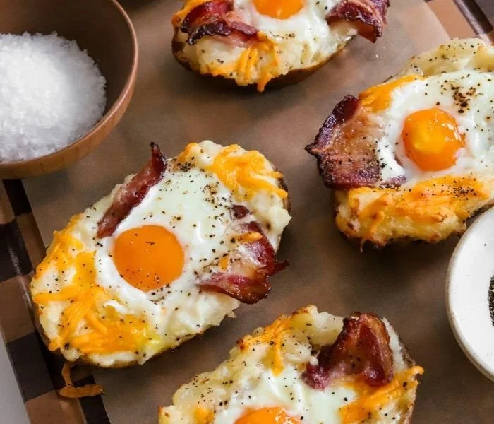Twice Baked Loaded Breakfast Potatoes topped with cheese and bacon.