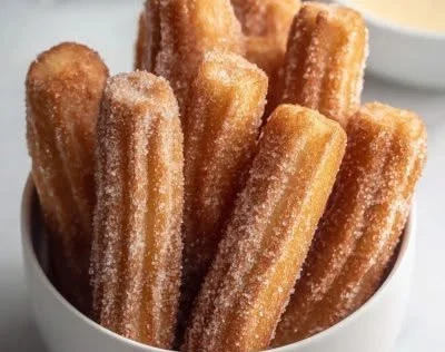 Delicious baked churro bites coated in cinnamon sugar ready to enjoy