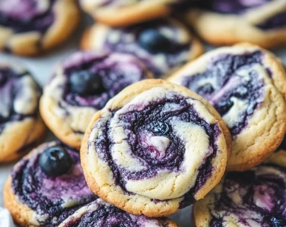 Blueberry cheesecake cookies topped with fresh blueberries and creamy cheesecake filling