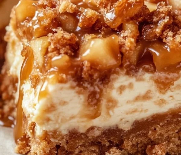 Delicious caramel apple cheesecake bars topped with caramel drizzle and apple slices